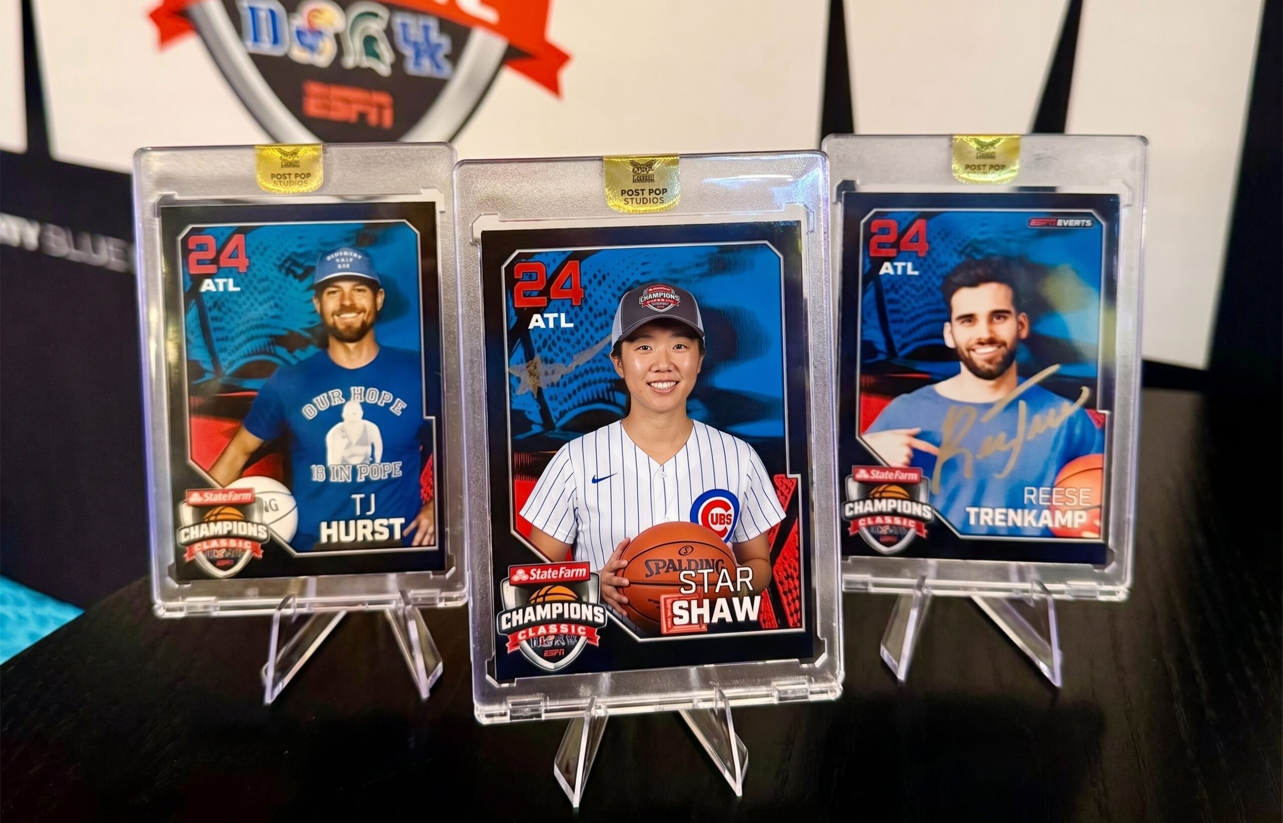 Three custom trading cards displayed in clear protective plastic cases