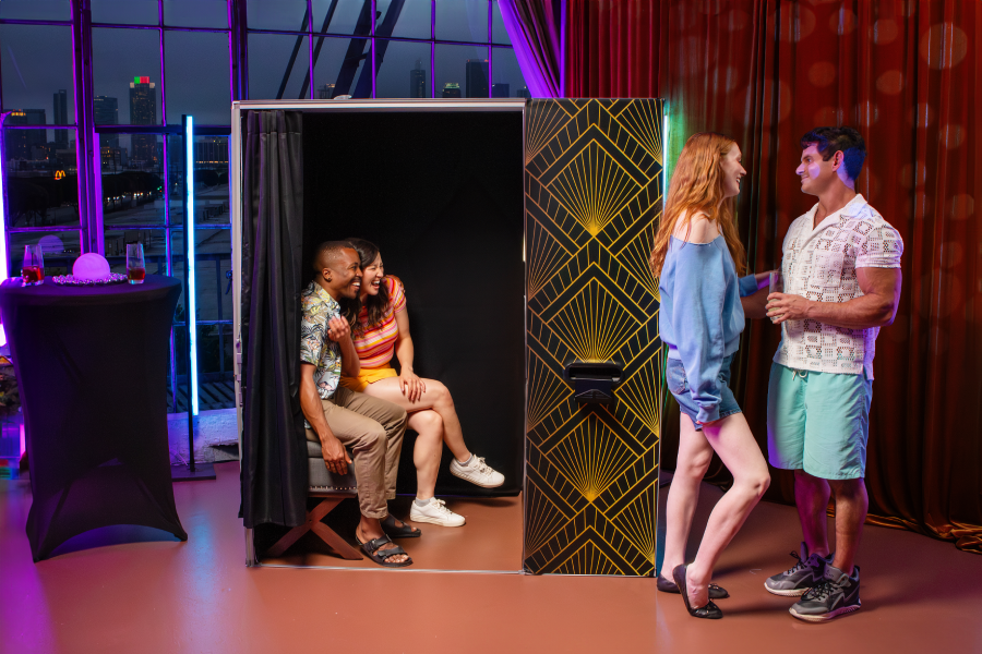 Guests enjoying an enclosed photo booth at a corporate event