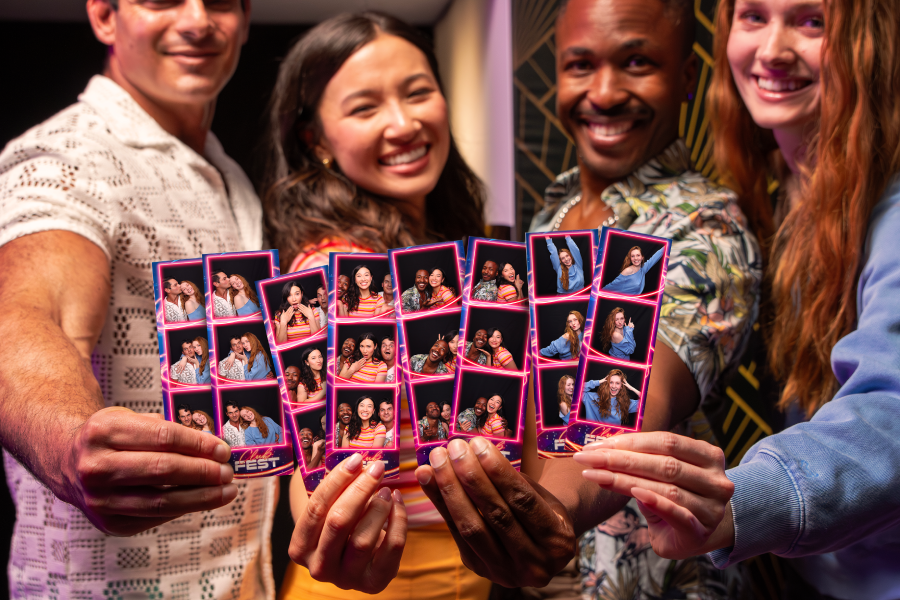 Guests using an enclosed photo booth at an event